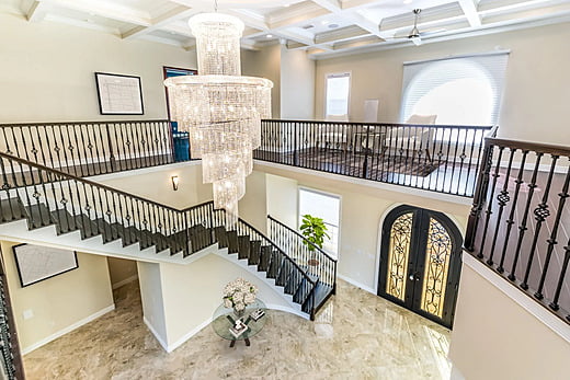 Staircase and chandelier in luxury Mediterranean home